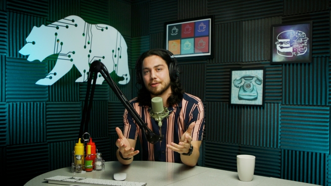 person speaking into a microphone in an audio studio